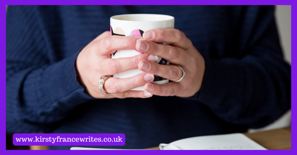 Image shows a woman in a navy jumper holding a cup of tea, thinking about how your marketing can focus on your customers.