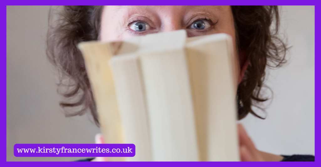 Image shows a dark haired woman hiding behind a stack of books, which is often my response when wondering how to talk about pricing.