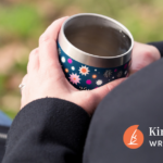 Image shows a woman's hands holding a cup, finding time to take a break.