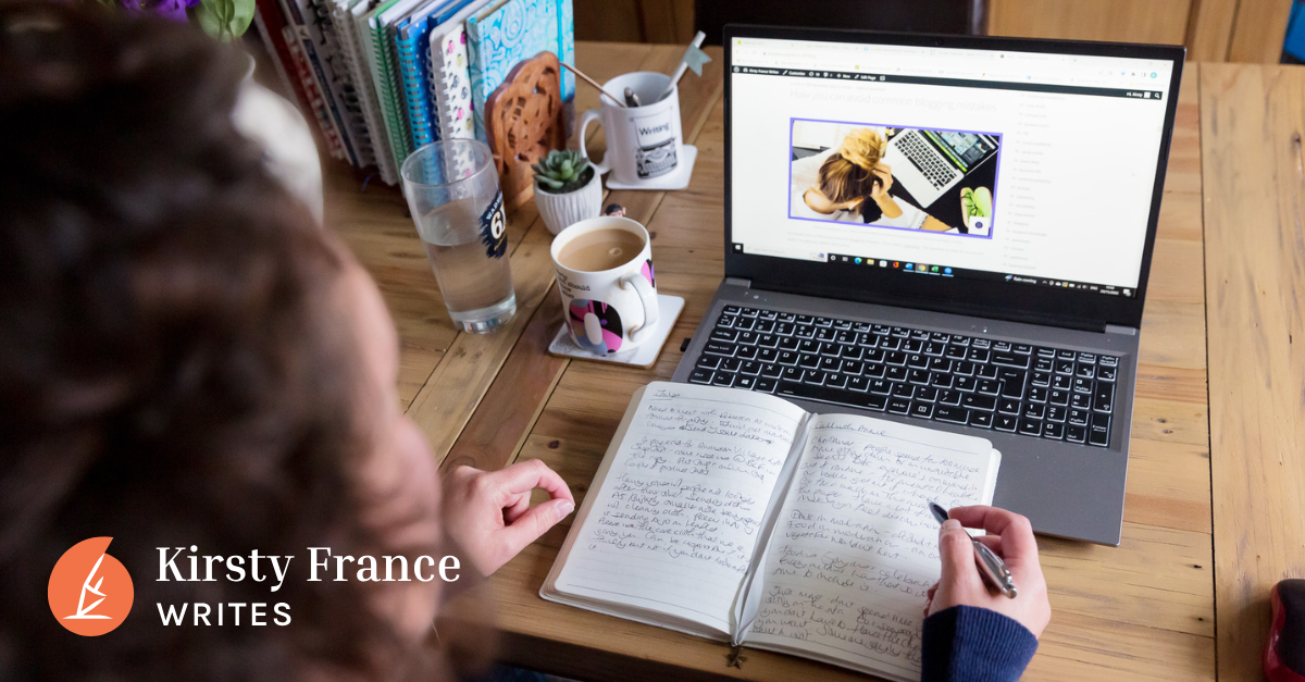 Image shows a woman with dark curly hair sitting at a laptop with a notebook, thinking about how to write for humans